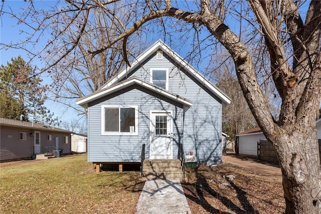 bungalow-style home with a front lawn