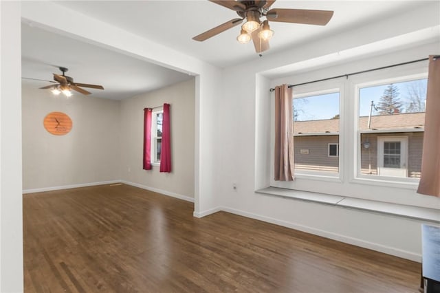 spare room featuring a ceiling fan, baseboards, and wood finished floors