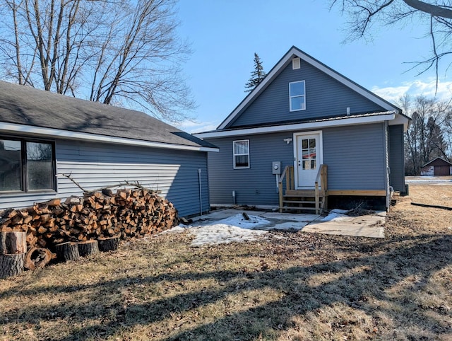 rear view of property with entry steps