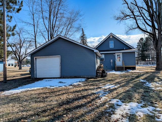 exterior space featuring entry steps, a detached garage, and an outbuilding