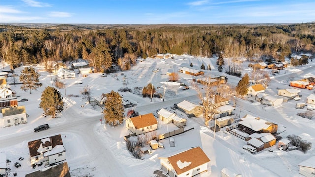 snowy aerial view featuring a view of trees