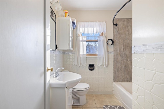 full bath with tile walls, toilet, vanity, shower / tub combination, and tile patterned flooring