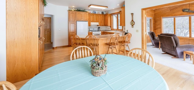 dining area with light wood-style floors, recessed lighting, and a healthy amount of sunlight