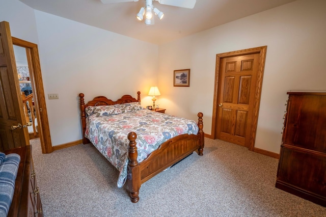 carpeted bedroom with ceiling fan and baseboards