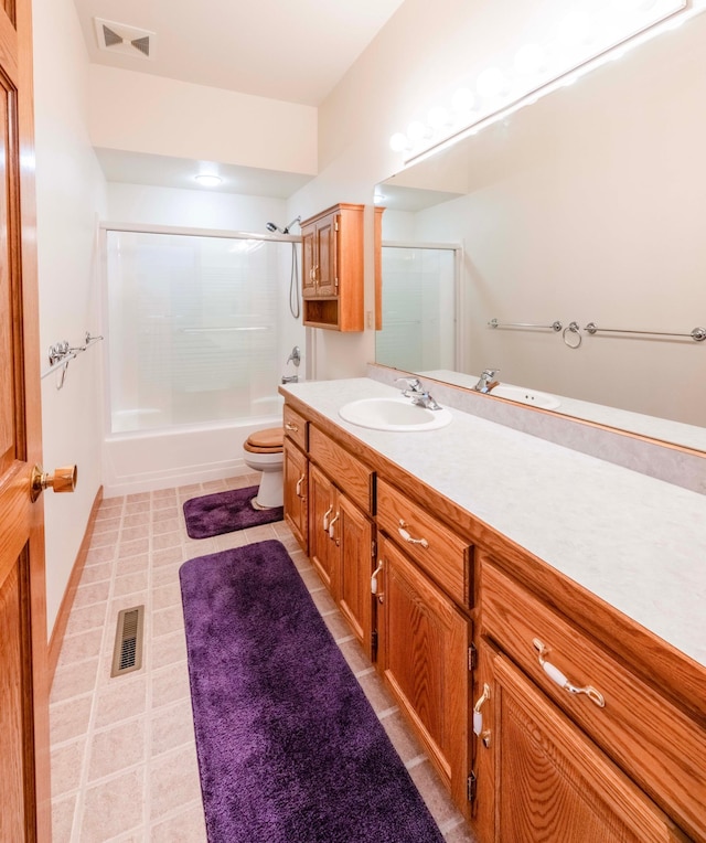 full bath with toilet, combined bath / shower with glass door, vanity, and visible vents