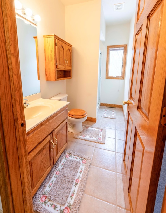 full bathroom featuring toilet, vanity, visible vents, a shower stall, and tile patterned floors