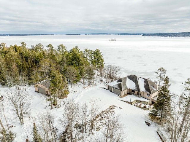 snowy aerial view with a water view