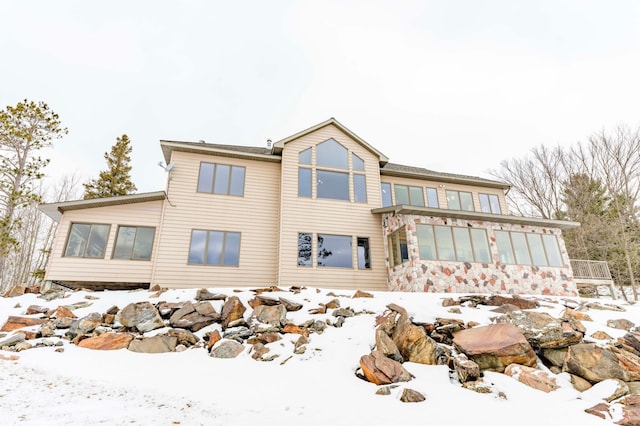 view of snow covered rear of property