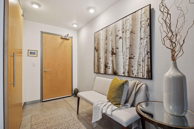 interior space featuring concrete floors and baseboards