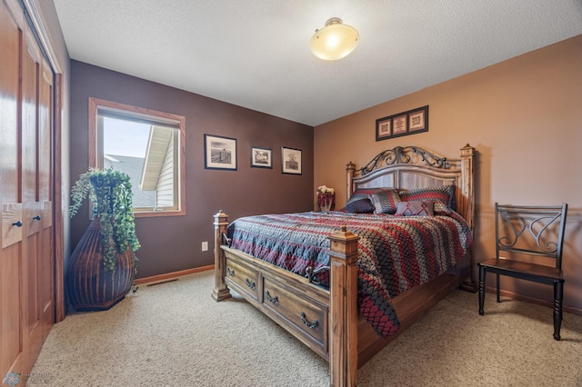 carpeted bedroom with a textured ceiling, visible vents, and baseboards