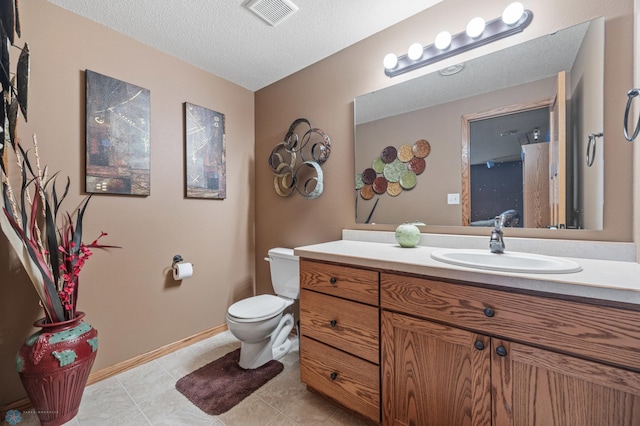 bathroom featuring baseboards, visible vents, toilet, a textured ceiling, and vanity