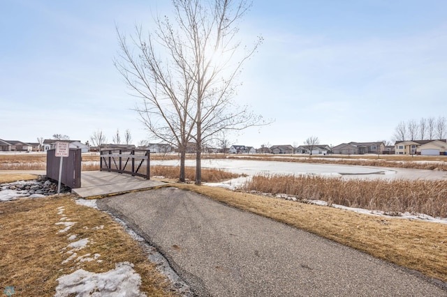 view of road with a residential view and a gate