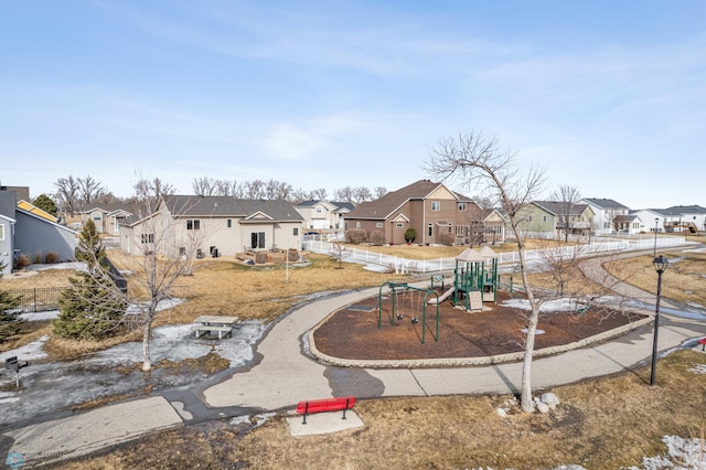 exterior space with a residential view, playground community, and fence