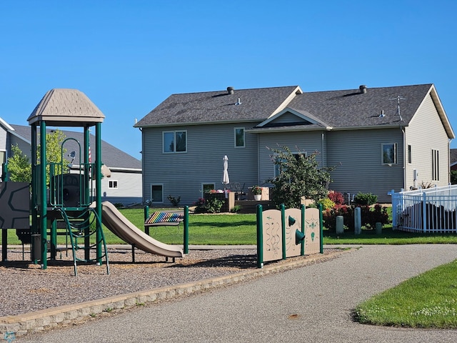 exterior space featuring fence and a lawn