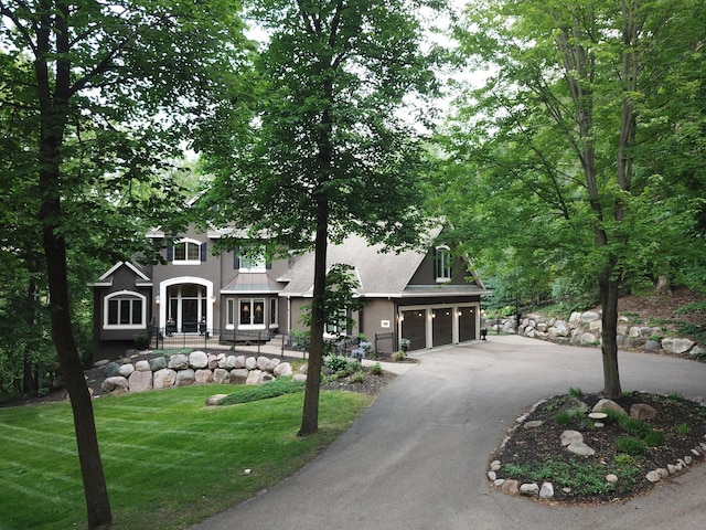 6155 Murray Ct, Shorewood, MN 55331 - view of front facade featuring driveway, a front yard, and stucco siding