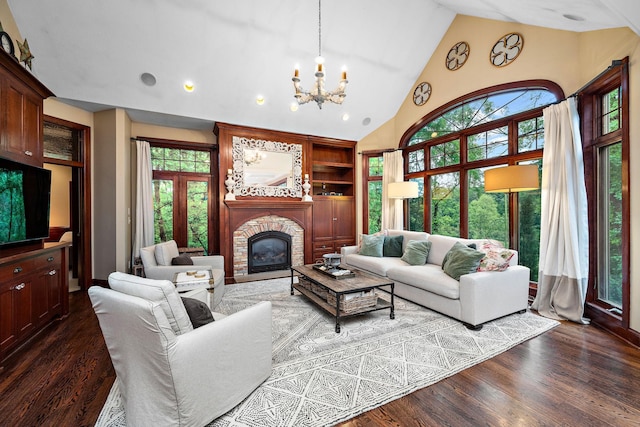6155 Murray Ct, Shorewood, MN 55331 - living room with a chandelier, dark wood finished floors, a glass covered fireplace, built in features, and high vaulted ceiling