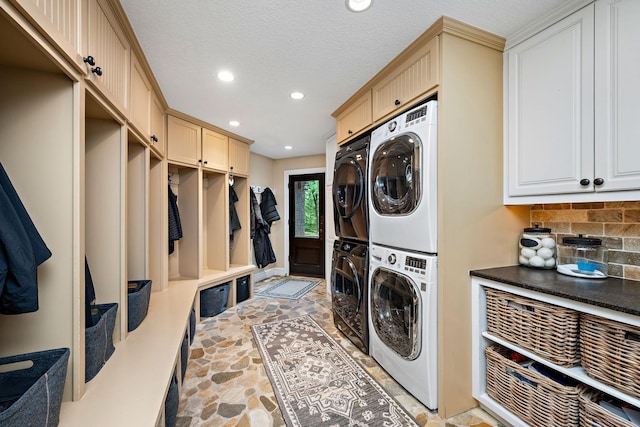 6155 Murray Ct, Shorewood, MN 55331 - washroom with light stone finish floors, stacked washer / drying machine, recessed lighting, washing machine and clothes dryer, and a textured ceiling