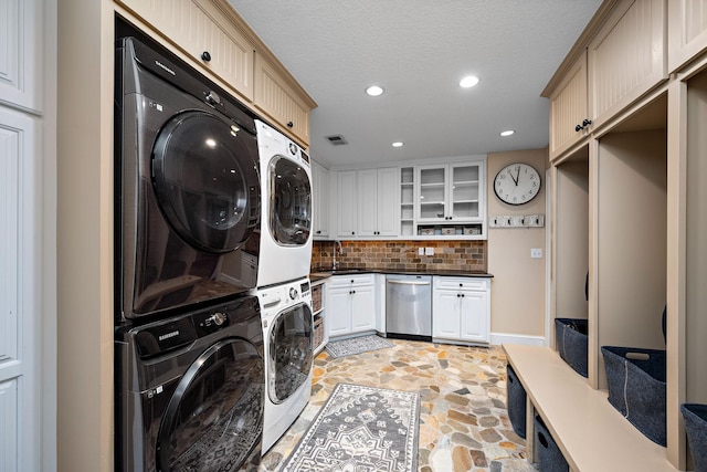 6155 Murray Ct, Shorewood, MN 55331 - laundry area with stacked washer / dryer, light stone finish flooring, recessed lighting, and a textured ceiling