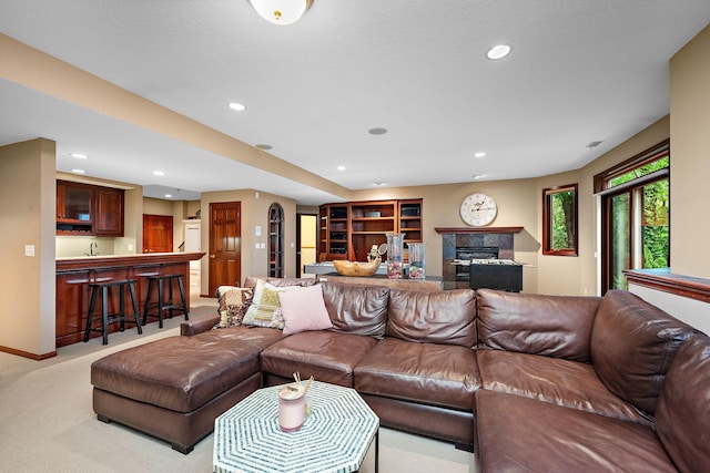 6155 Murray Ct, Shorewood, MN 55331 - living area with light colored carpet, wet bar, recessed lighting, and a glass covered fireplace