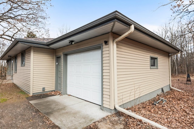 view of property exterior with an attached garage