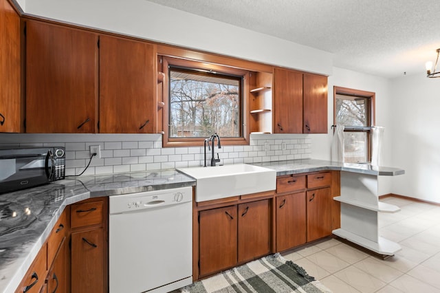 kitchen with black microwave, white dishwasher, a sink, and plenty of natural light