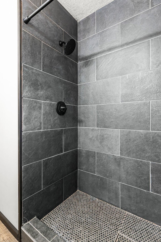 bathroom with a tile shower