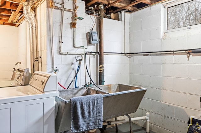 interior space featuring laundry area, washer and clothes dryer, and a sink