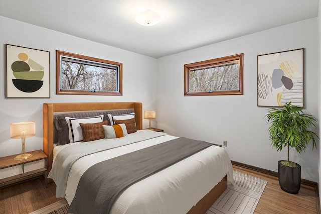 bedroom featuring baseboards and wood finished floors