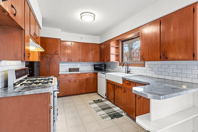kitchen with white appliances, brown cabinetry, open shelves, a sink, and under cabinet range hood