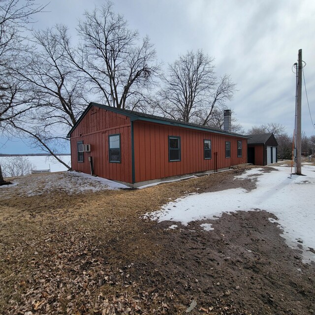 43404 Bills Beach Rd, Edna Twp, MN 56528 - view of side of home with a chimney and board and batten siding