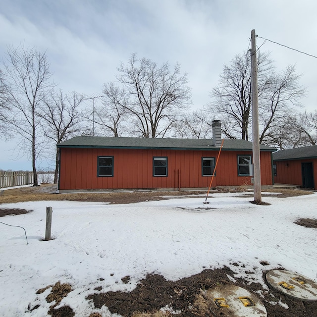 43404 Bills Beach Rd, Edna Twp, MN 56528 - snow covered rear of property with fence and board and batten siding