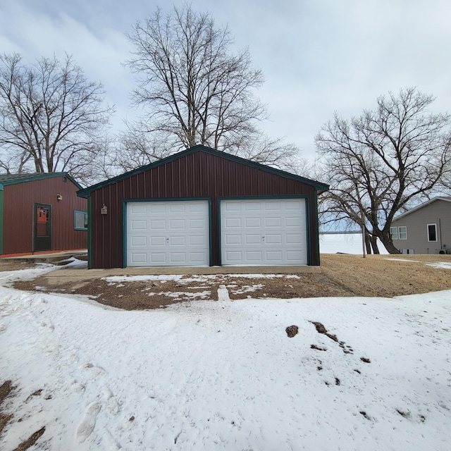 43404 Bills Beach Rd, Edna Twp, MN 56528 - snow covered garage with a detached garage