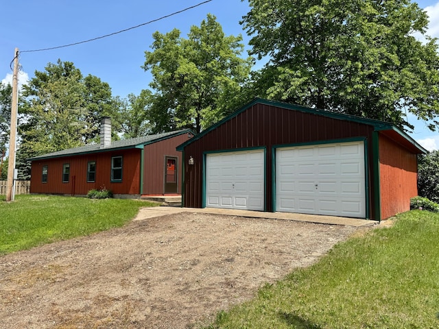43404 Bills Beach Rd, Edna Twp, MN 56528 - ranch-style house featuring a detached garage, a front yard, a chimney, driveway, and an outdoor structure