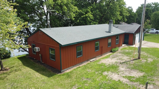 43404 Bills Beach Rd, Edna Twp, MN 56528 - view of side of home featuring driveway, a yard, and a chimney