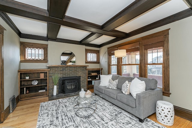 living area with a healthy amount of sunlight, light wood-style flooring, and coffered ceiling