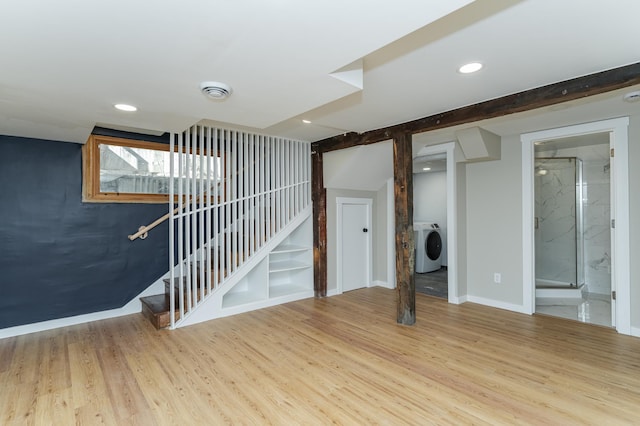 below grade area with washer / dryer, baseboards, light wood-style flooring, stairs, and recessed lighting