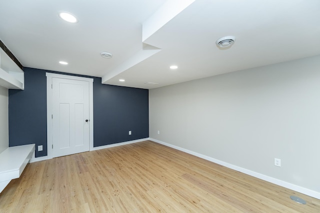 finished basement with light wood-style flooring, baseboards, and recessed lighting