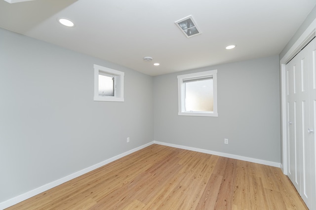 interior space featuring visible vents, light wood finished floors, and baseboards