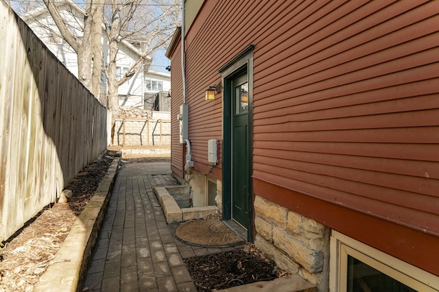 view of side of property featuring fence