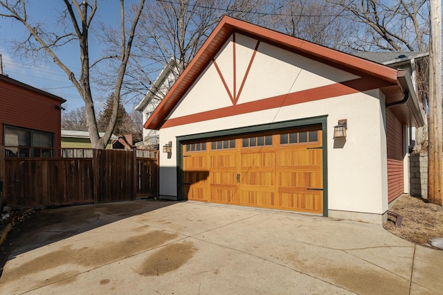 detached garage featuring fence