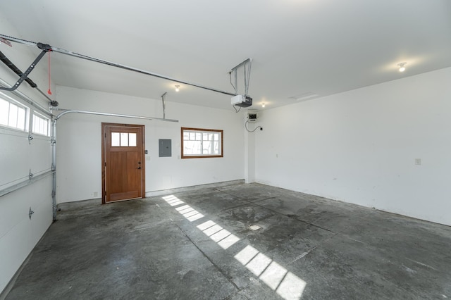 garage with a garage door opener and electric panel