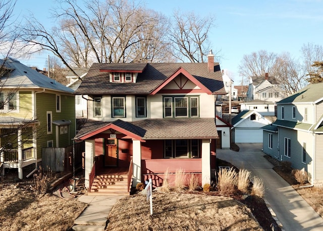 view of front facade featuring an outbuilding, a chimney, and stucco siding