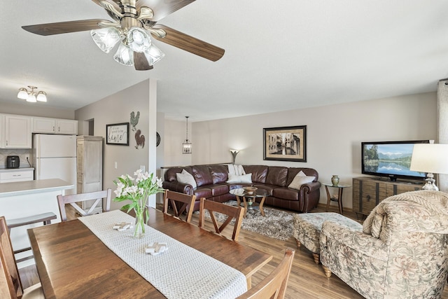 dining room featuring light wood-type flooring and a ceiling fan