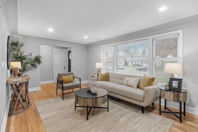 living room featuring recessed lighting, light wood-style flooring, and baseboards