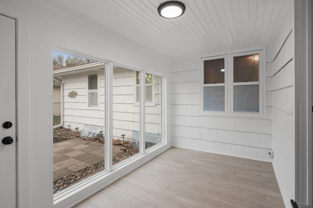 unfurnished sunroom featuring wooden ceiling