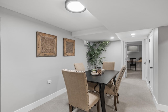 dining space featuring recessed lighting, light carpet, and baseboards