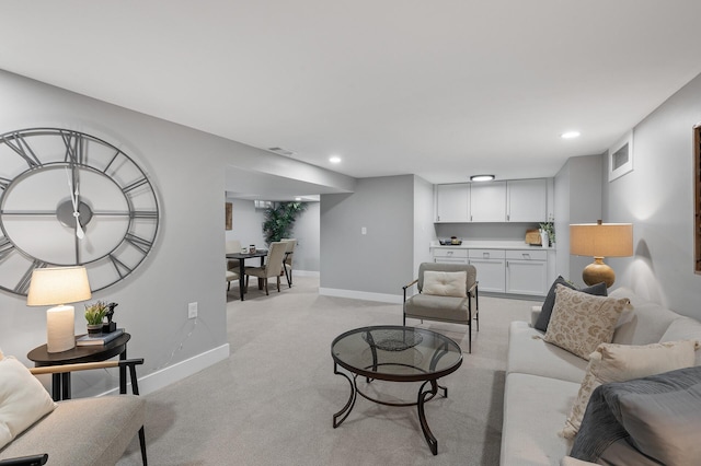 living room with light carpet, recessed lighting, visible vents, and baseboards