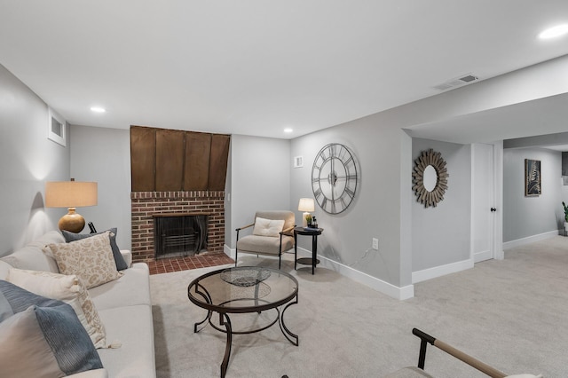 living area featuring light colored carpet, visible vents, a fireplace, and baseboards