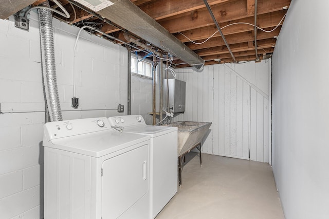 laundry room featuring laundry area, a sink, and washer and clothes dryer