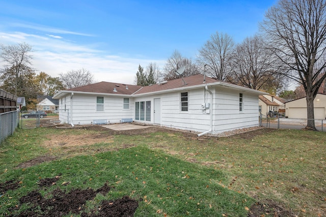 back of property with a patio area, a fenced backyard, a gate, and a yard